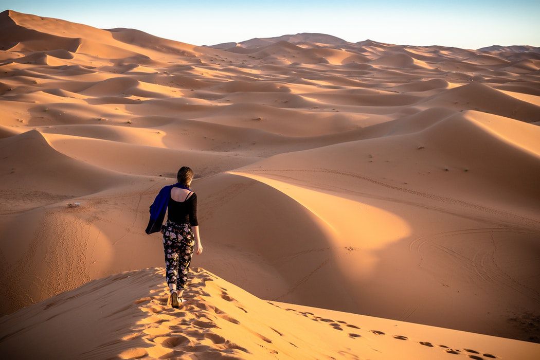 a woman contemplating the desert of Merzouga